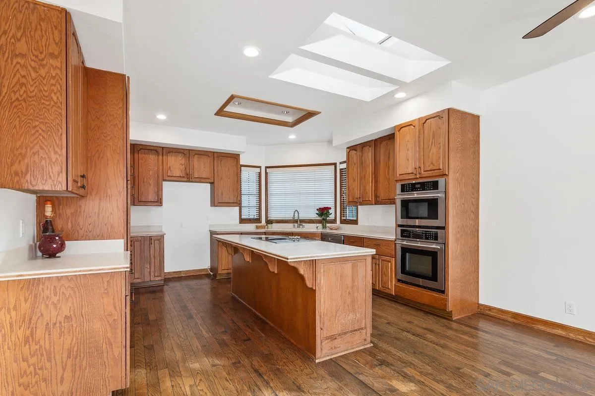 15918 Lime Grove Road Poway, CA 92064 - Photo 11 of 53 a kitchen with stainless steel appliances a sink stove and refrigerator