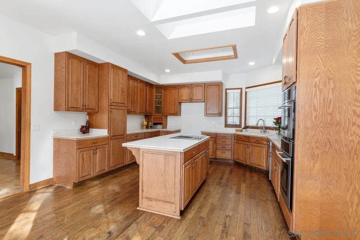 15918 Lime Grove Road Poway, CA 92064 - Photo 12 of 53 a kitchen with a stove top oven sink and cabinets
