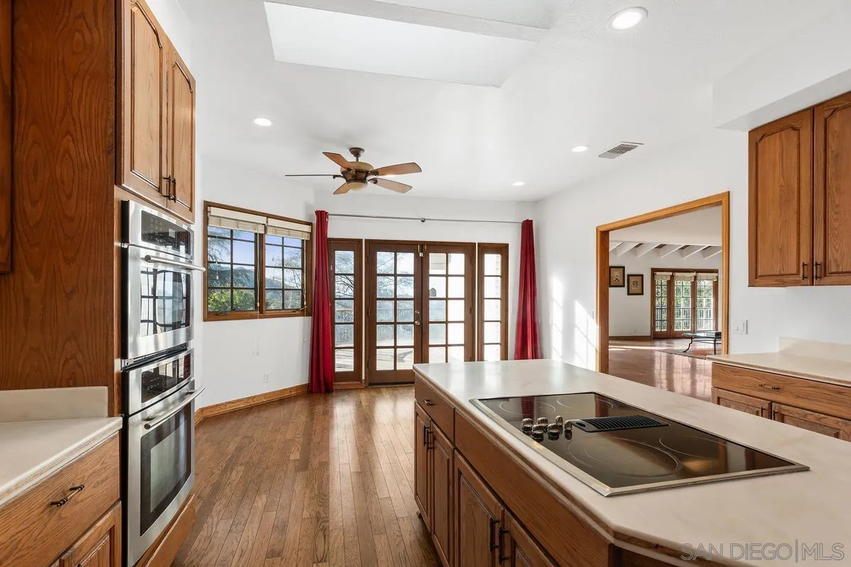 15918 Lime Grove Road Poway, CA 92064 - Photo 13 of 53 a kitchen with stainless steel appliances granite countertop a stove and a refrigerator