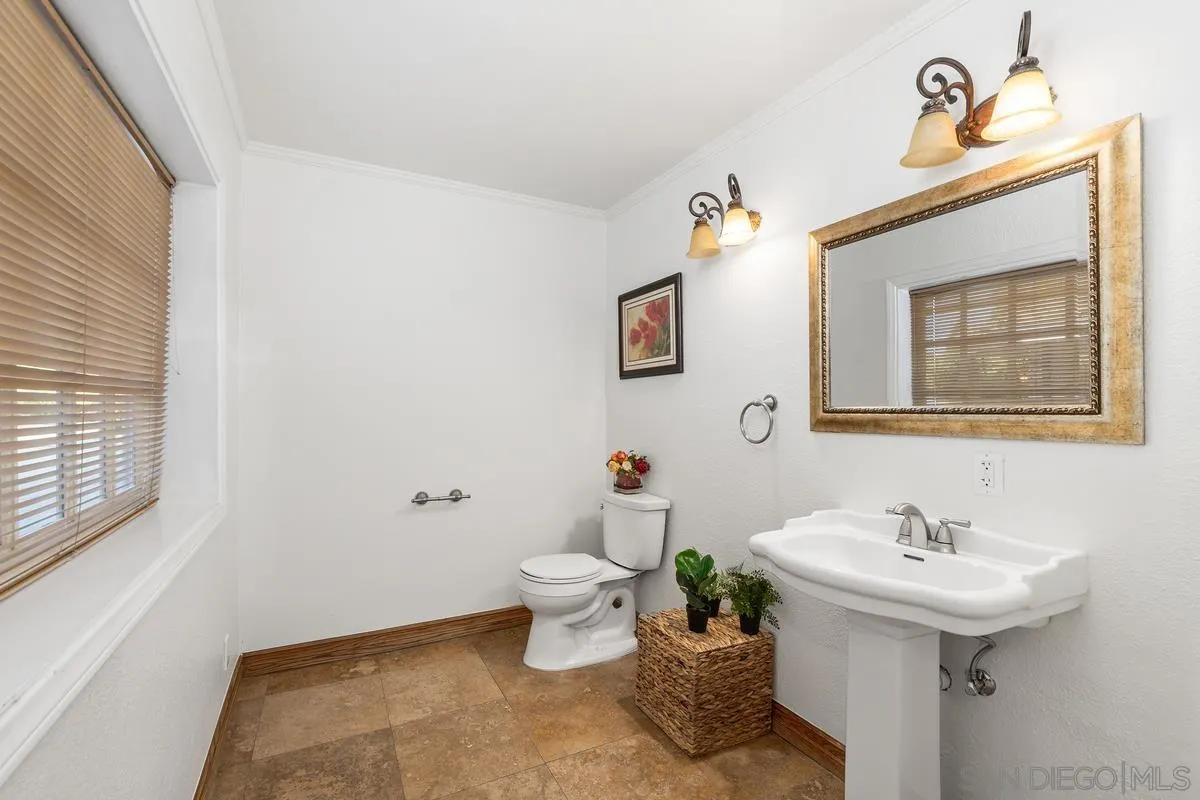 15918 Lime Grove Road Poway, CA 92064 - Photo 16 of 53 a bathroom with a sink toilet and a mirror