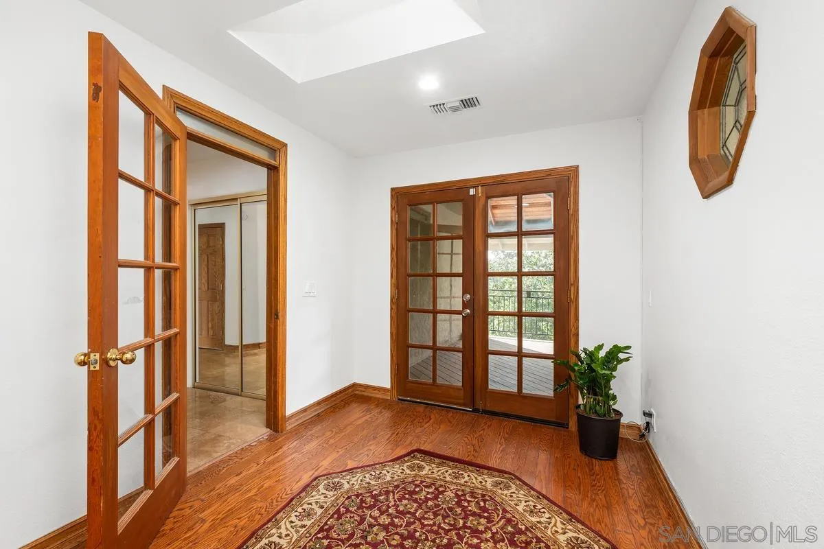 15918 Lime Grove Road Poway, CA 92064 - Photo 17 of 53 a view of front door with wooden floor and a potted plant