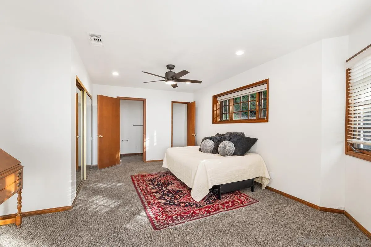 15918 Lime Grove Road Poway, CA 92064 - Photo 33 of 53 a bedroom with a bed and a chandelier