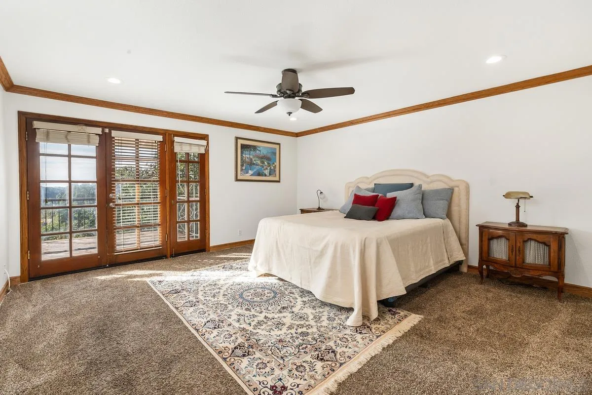 15918 Lime Grove Road Poway, CA 92064 - Photo 7 of 53 a bedroom with a large bed and a chandelier