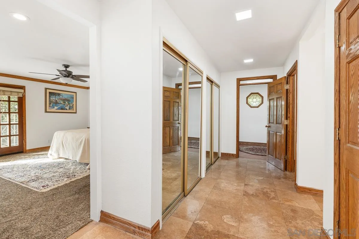 15918 Lime Grove Road Poway, CA 92064 - Photo 8 of 53 a view of a bedroom with wooden floor and cabinet