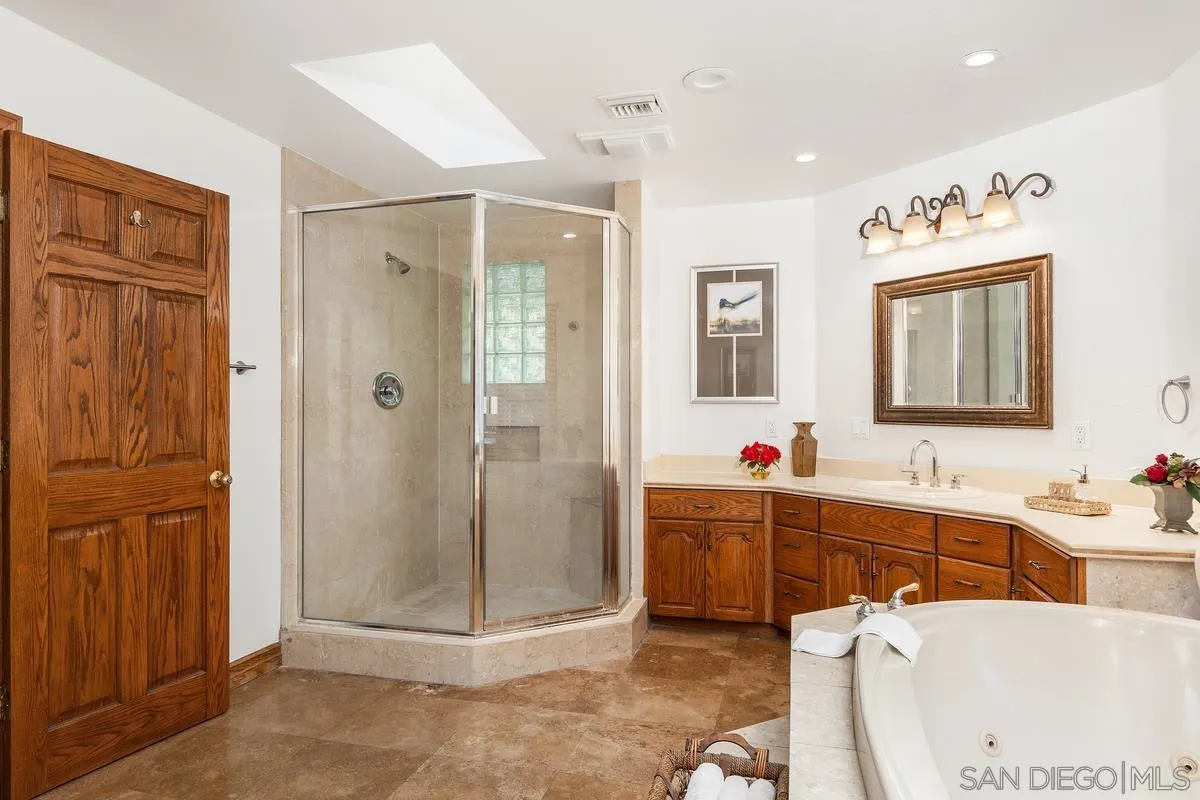 15918 Lime Grove Road Poway, CA 92064 - Photo 10 of 53 a bathroom with a tub sink shower and mirror