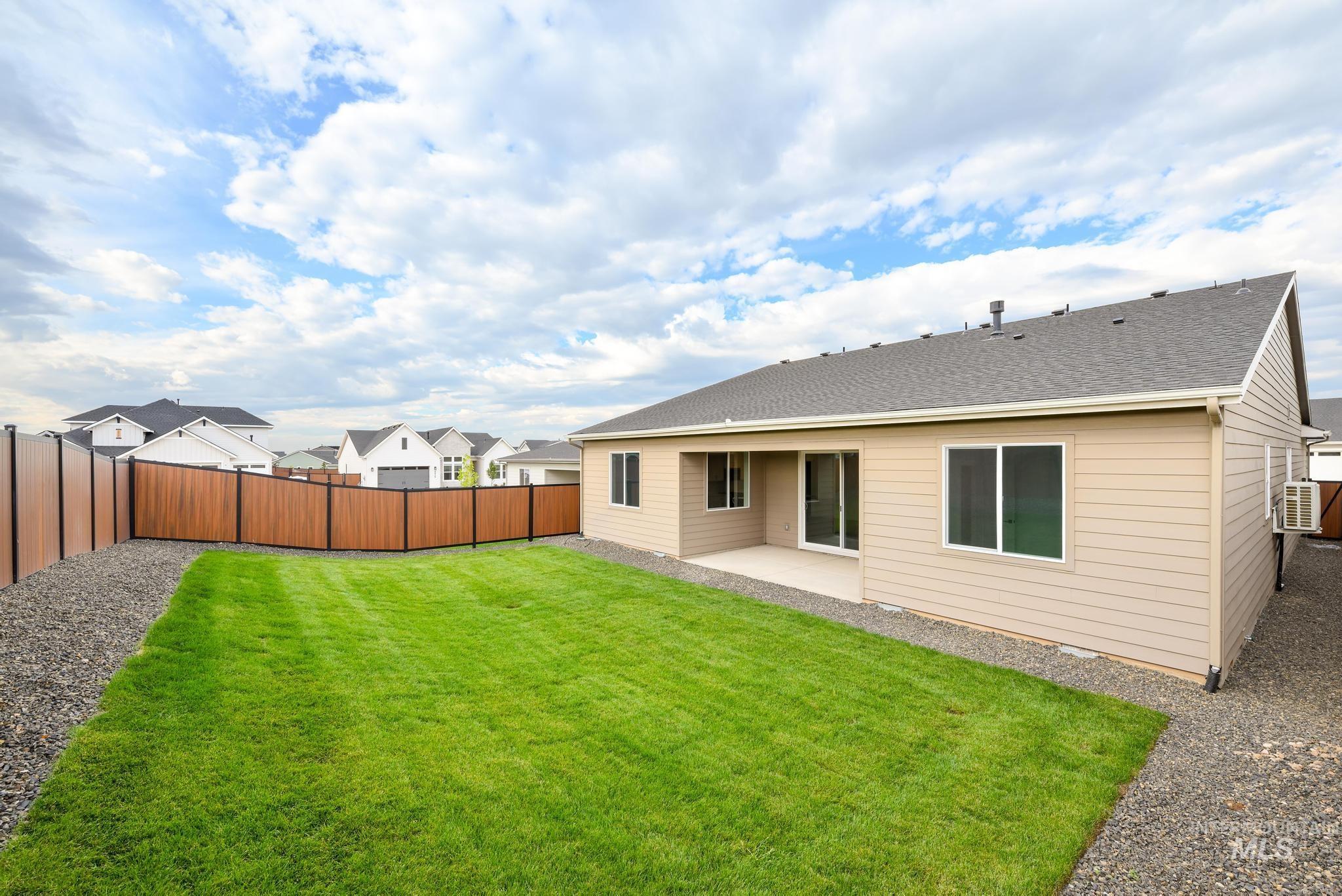 1705 West Paloma Rdg Street Kuna, ID 83634 - Photo 11 of 11 Back of house with a patio, a fenced backyard, a shingled roof, and a residential view
