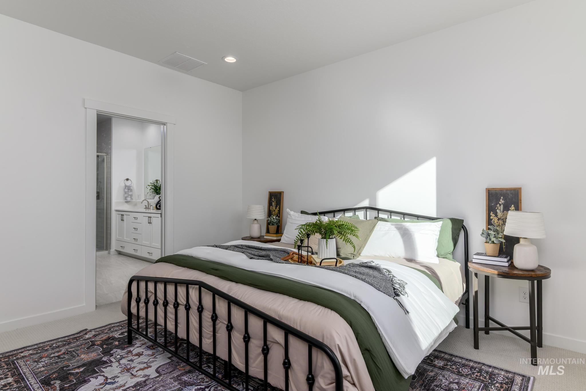 1705 West Paloma Rdg Street Kuna, ID 83634 - Photo 8 of 11 Bedroom with light carpet, connected bathroom, and recessed lighting