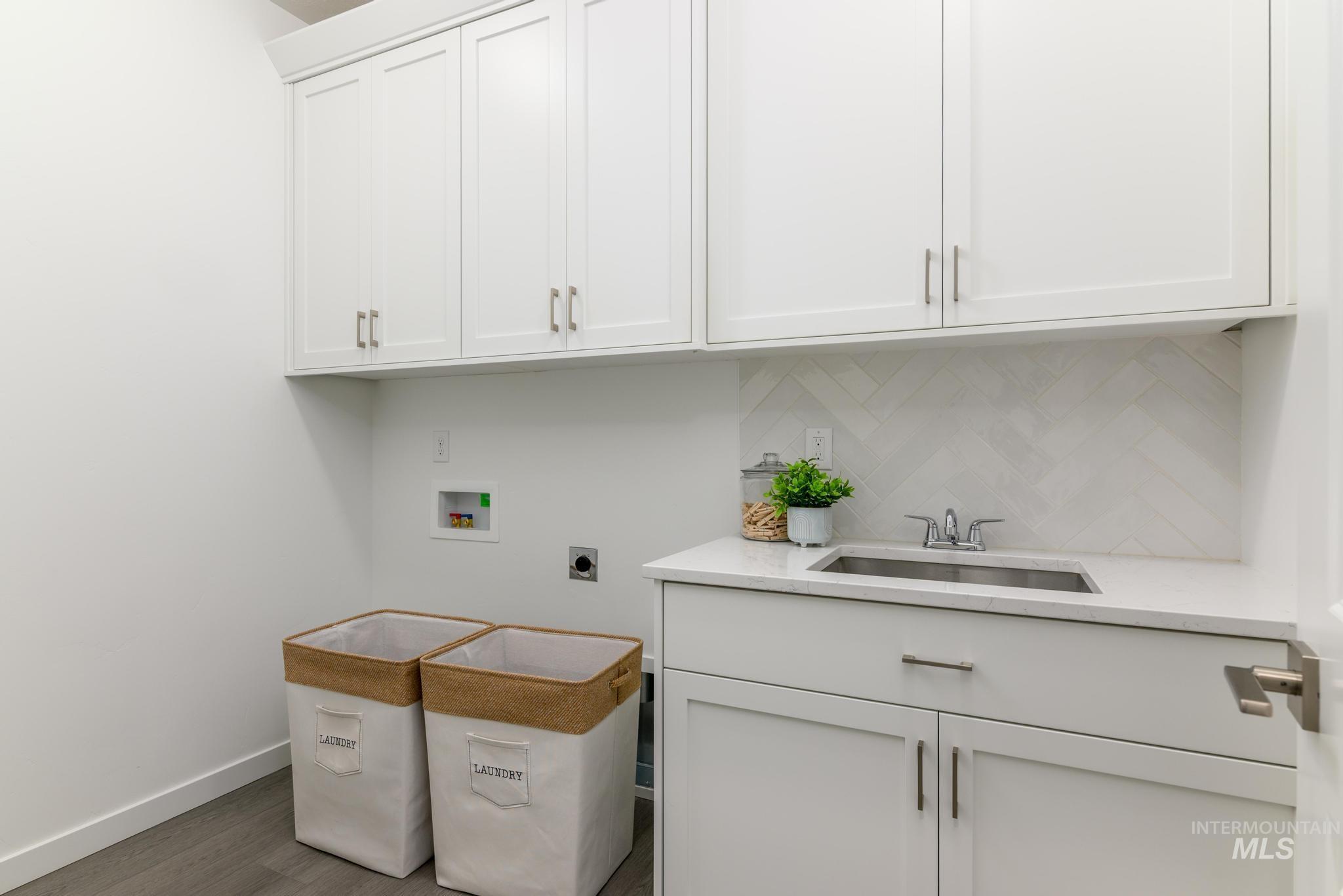 1705 West Paloma Rdg Street Kuna, ID 83634 - Photo 10 of 11 Laundry area with cabinet space, wood finished floors, washer hookup, and hookup for an electric dryer