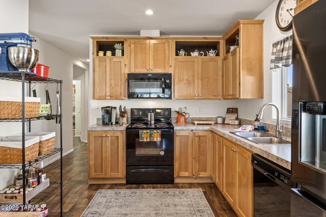 a kitchen with stainless steel appliances granite countertop a refrigerator stove and sink