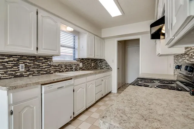 a kitchen with stainless steel appliances a stove a sink and a refrigerator