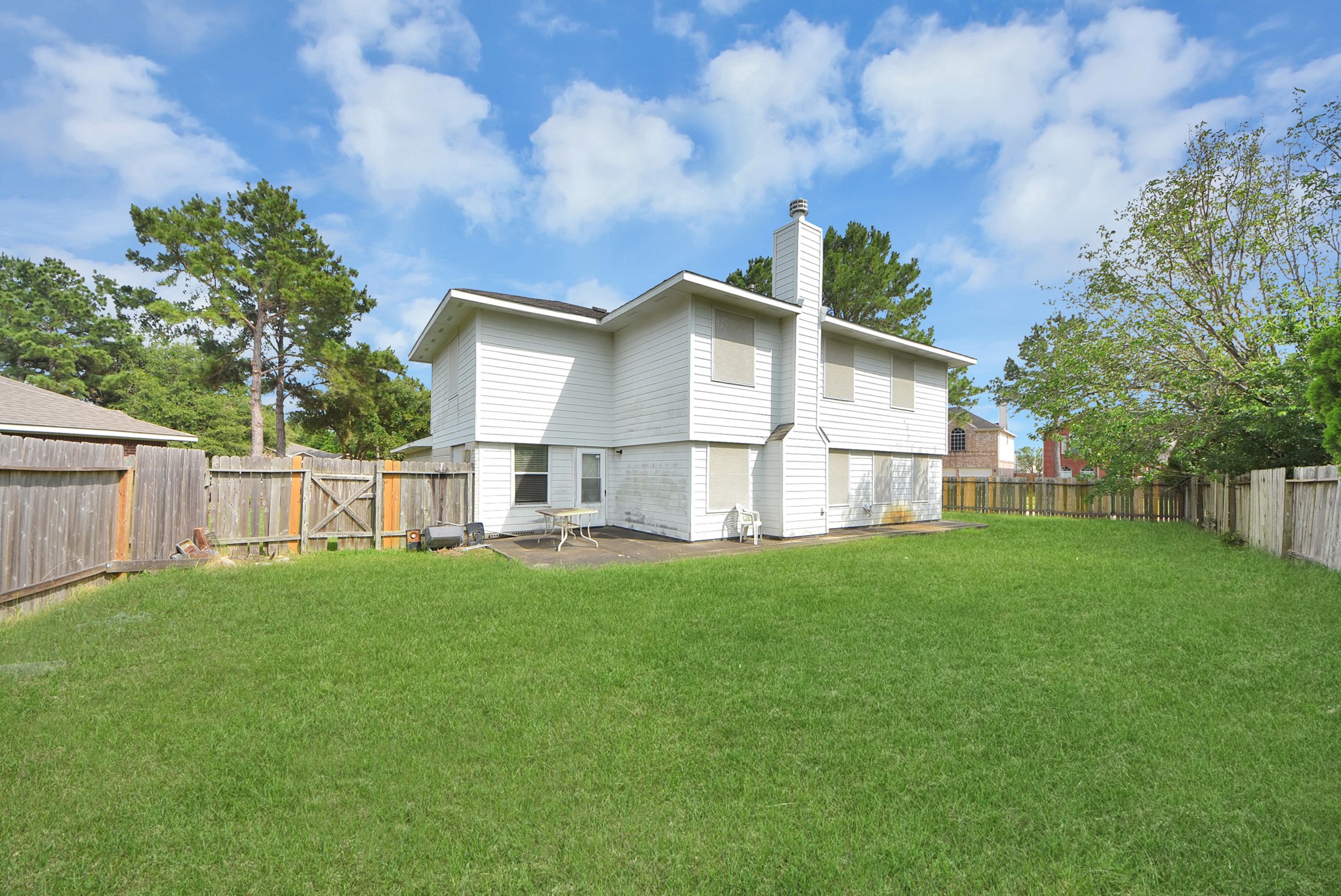 10003 Dakota Ridge Court Houston, TX 77095 - Photo 28 of 30 a view of a house with a yard and a large tree