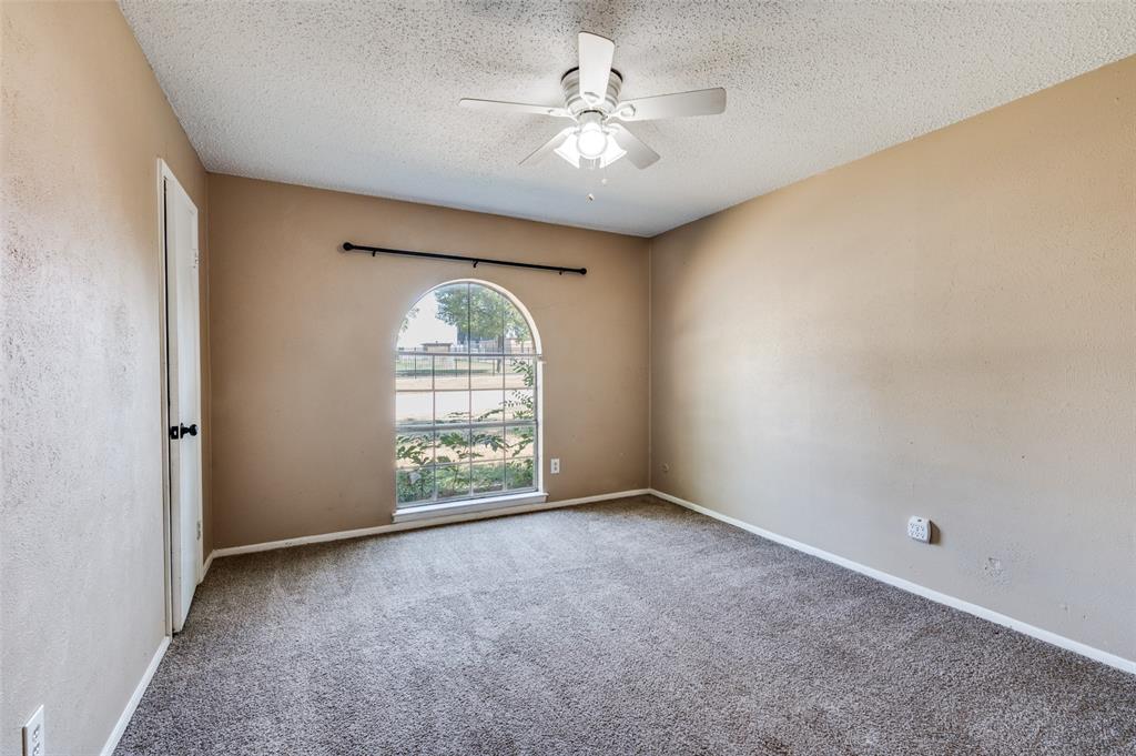 2102 East Timberview Lane Arlington, TX 76014 - Photo 5 of 10 an empty room with windows and ceiling fan