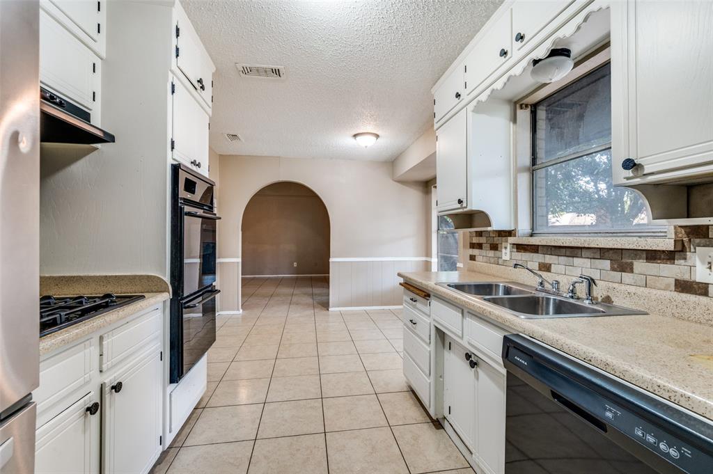 2102 East Timberview Lane Arlington, TX 76014 - Photo 9 of 10 a kitchen with a sink and cabinets