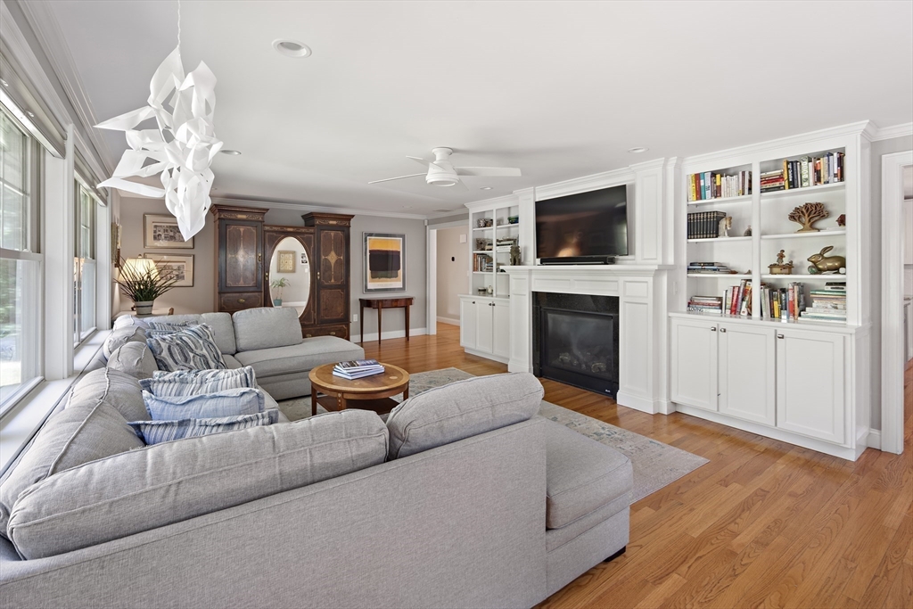 22 Peachtree Road Lexington, MA 02420 - Photo 13 of 42 a living room with furniture a flat screen tv and a fireplace