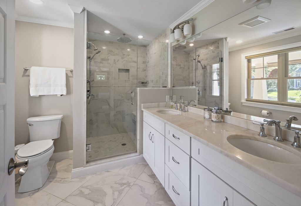 22 Peachtree Road Lexington, MA 02420 - Photo 19 of 42 a bathroom with a granite countertop sink a toilet a shower and a mirror