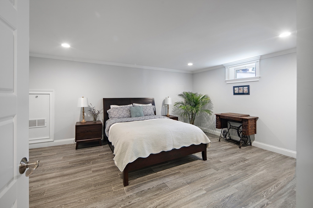 22 Peachtree Road Lexington, MA 02420 - Photo 26 of 42 a bedroom with a bed and wooden floor