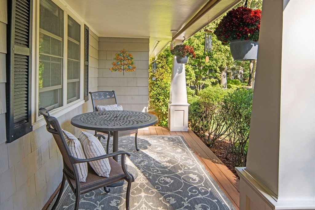 22 Peachtree Road Lexington, MA 02420 - Photo 3 of 42 a view of balcony with a table and chairs and potted plants