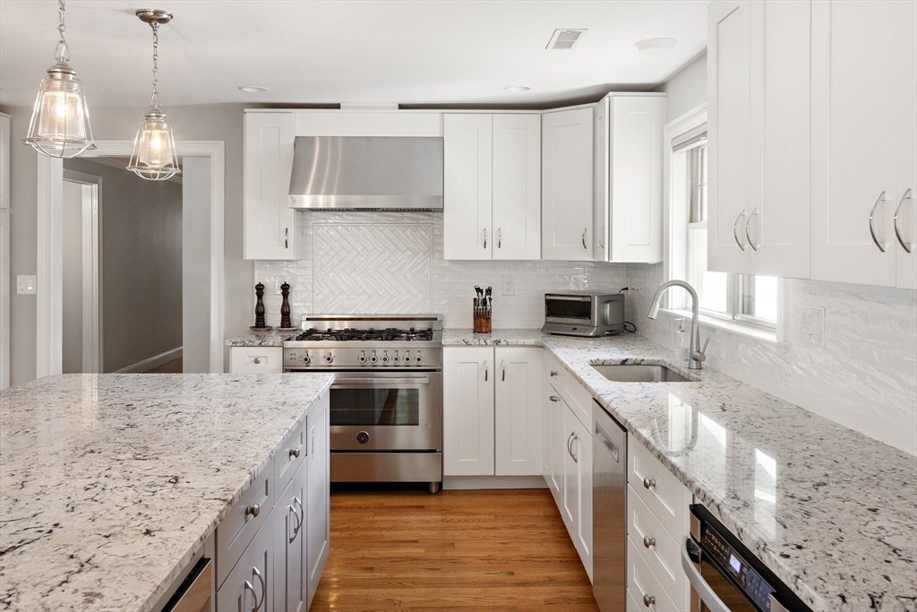 22 Peachtree Road Lexington, MA 02420 - Photo 5 of 42 a kitchen with a sink stove and refrigerator