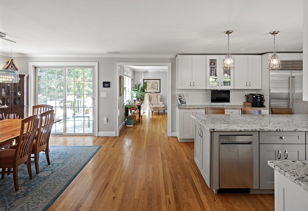 22 Peachtree Road Lexington, MA 02420 - Photo 9 of 42 a kitchen with stainless steel appliances granite countertop wooden floors and view of living room