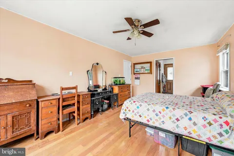 a bedroom with a bed dresser and a window