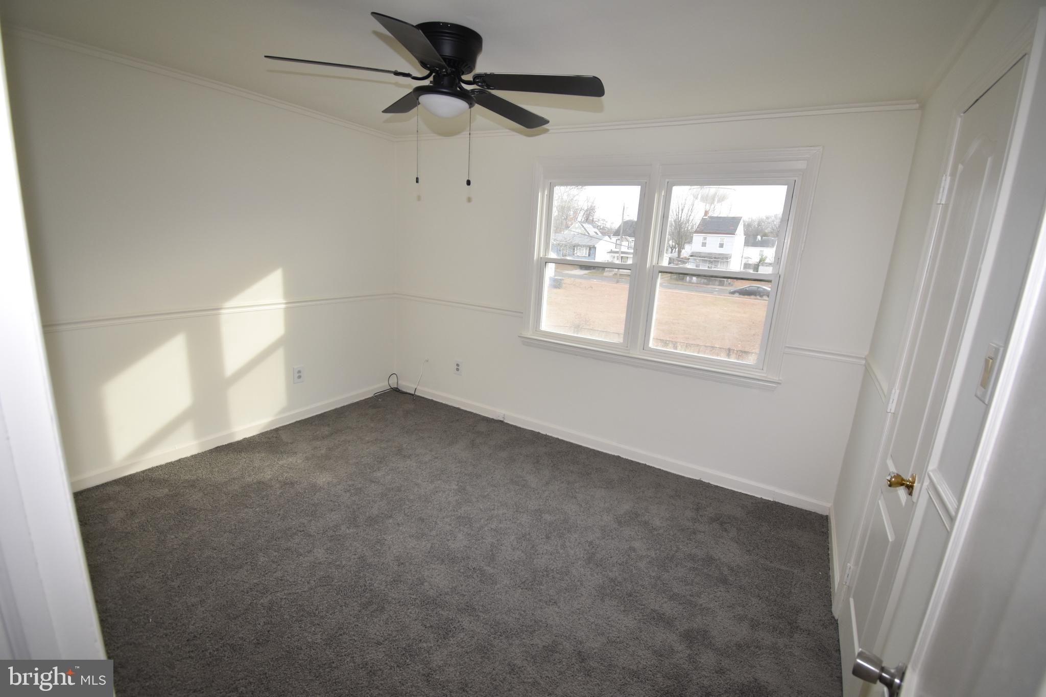 76 West 4th Street Burlington, NJ 08016 - Photo 14 of 15 an empty room with windows and fan