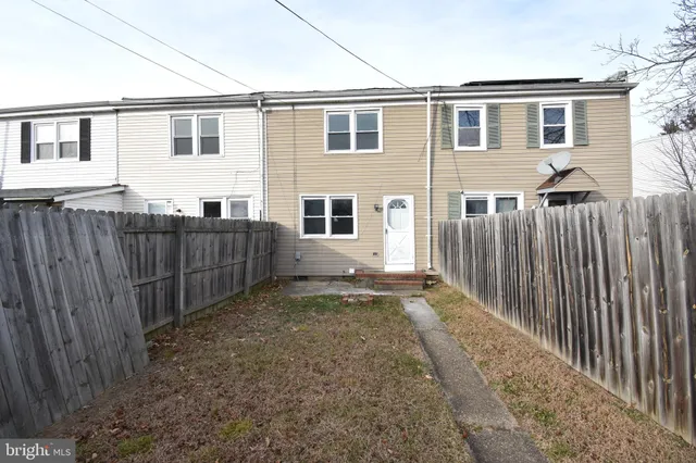 a view of a house with wooden fence