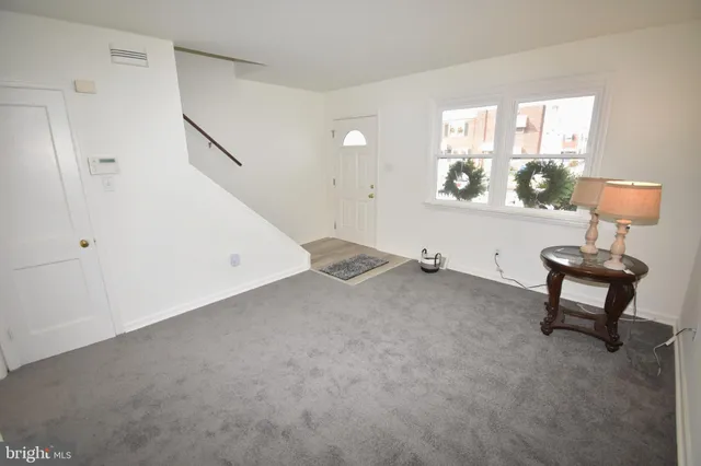 a view of a livingroom with furniture and a window