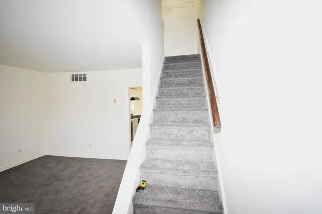 a view of staircase with white walls