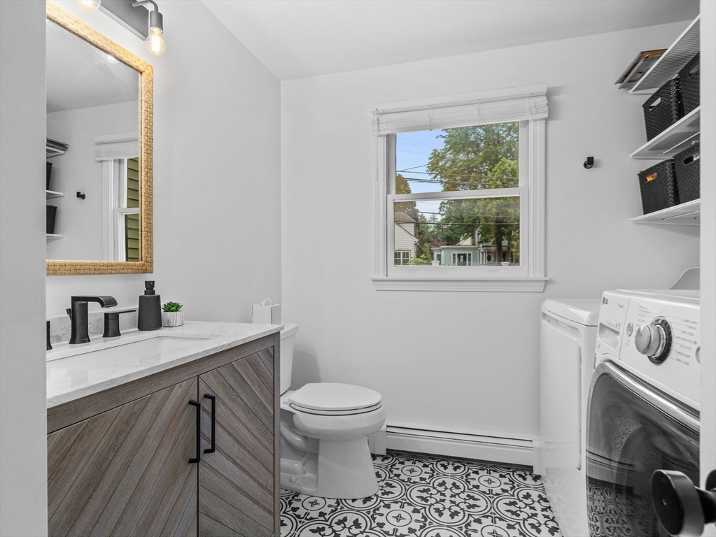 168 Maple Street Boston, MA 02132 - Photo 11 of 39 a bathroom with a sink toilet and window