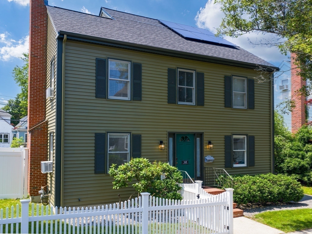 168 Maple Street Boston, MA 02132 - Photo 14 of 39 a front view of a house with a garden