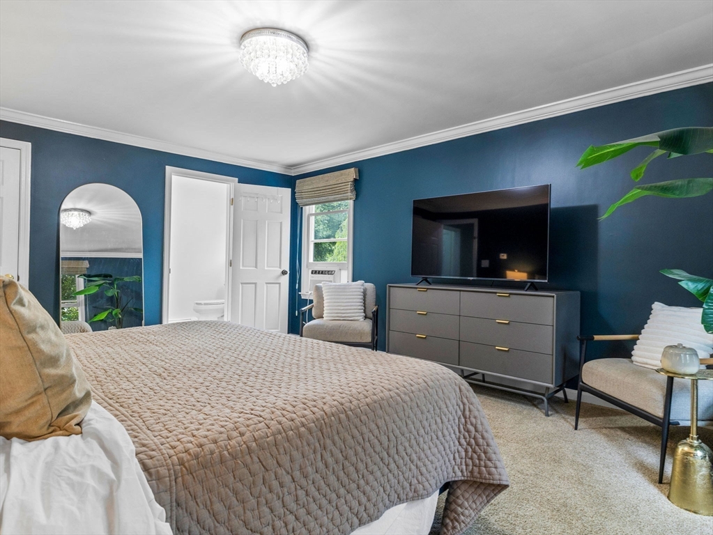 168 Maple Street Boston, MA 02132 - Photo 19 of 39 a bedroom with a bed and a flat screen tv