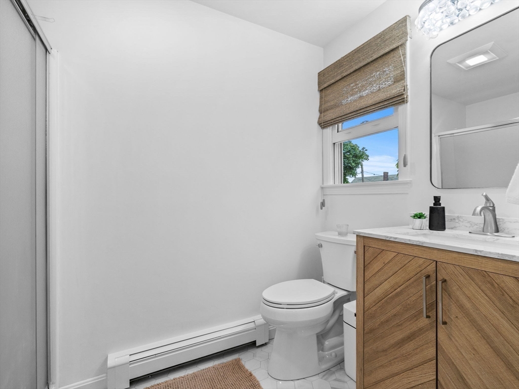 168 Maple Street Boston, MA 02132 - Photo 20 of 39 a bathroom with a toilet sink and mirror