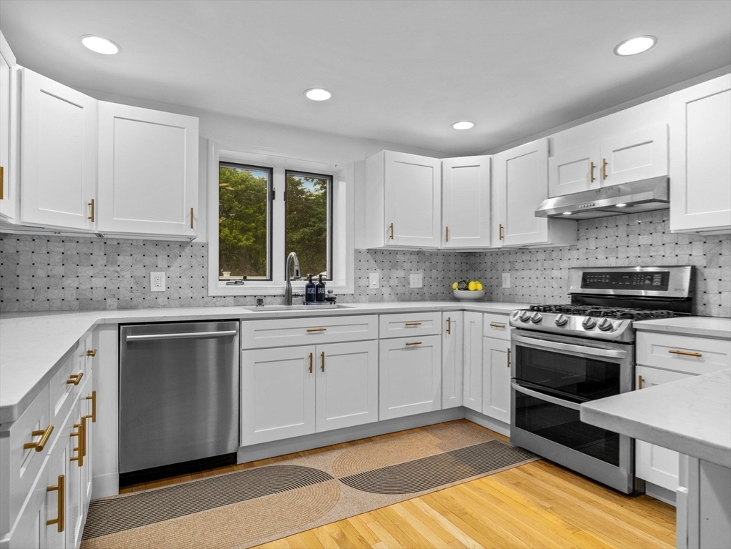 168 Maple Street Boston, MA 02132 - Photo 2 of 39 a kitchen with stainless steel appliances granite countertop a stove a sink and a microwave