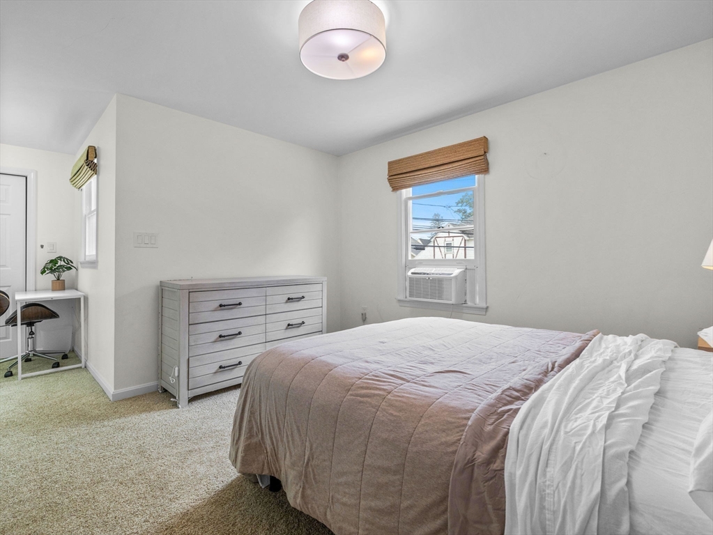 168 Maple Street Boston, MA 02132 - Photo 24 of 39 a bedroom with a bed and a window