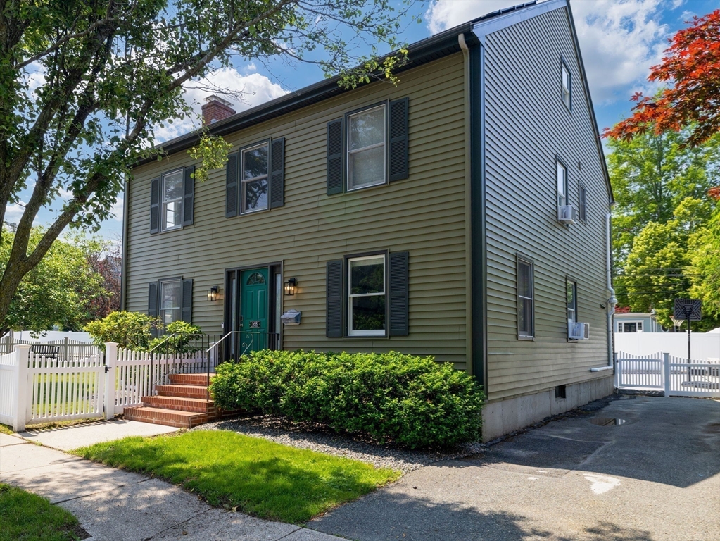 168 Maple Street Boston, MA 02132 - Photo 30 of 39 a front view of a house with a yard and potted plants