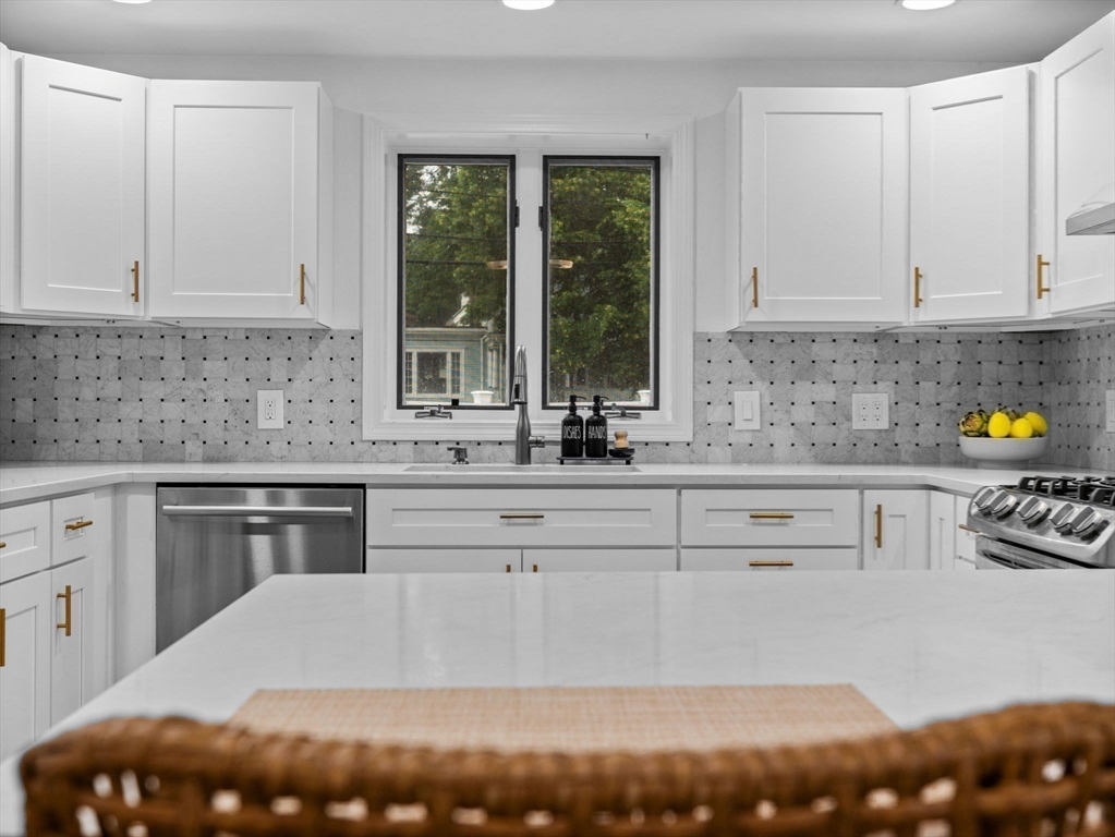 168 Maple Street Boston, MA 02132 - Photo 4 of 39 a kitchen with stainless steel appliances white cabinets and a counter space