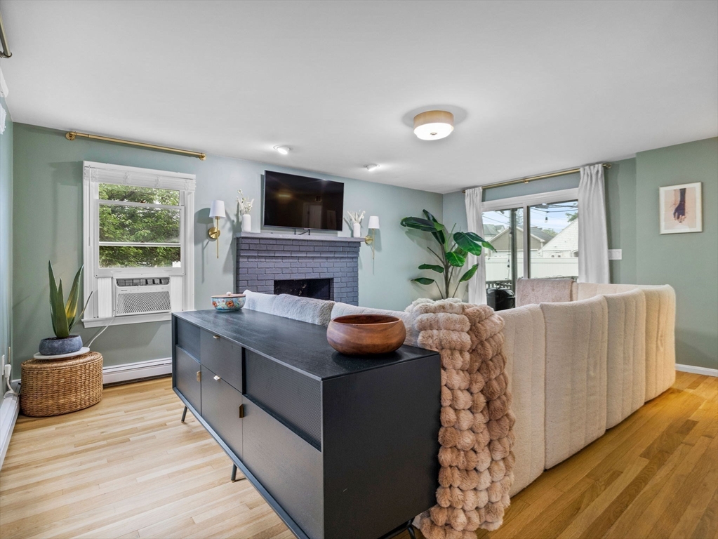 168 Maple Street Boston, MA 02132 - Photo 8 of 39 a living room with furniture fireplace and window