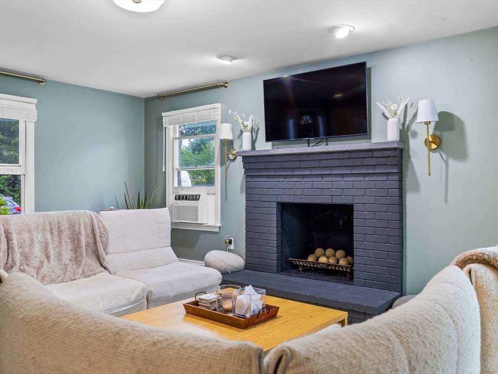168 Maple Street Boston, MA 02132 - Photo 9 of 39 a living room with furniture and a fireplace