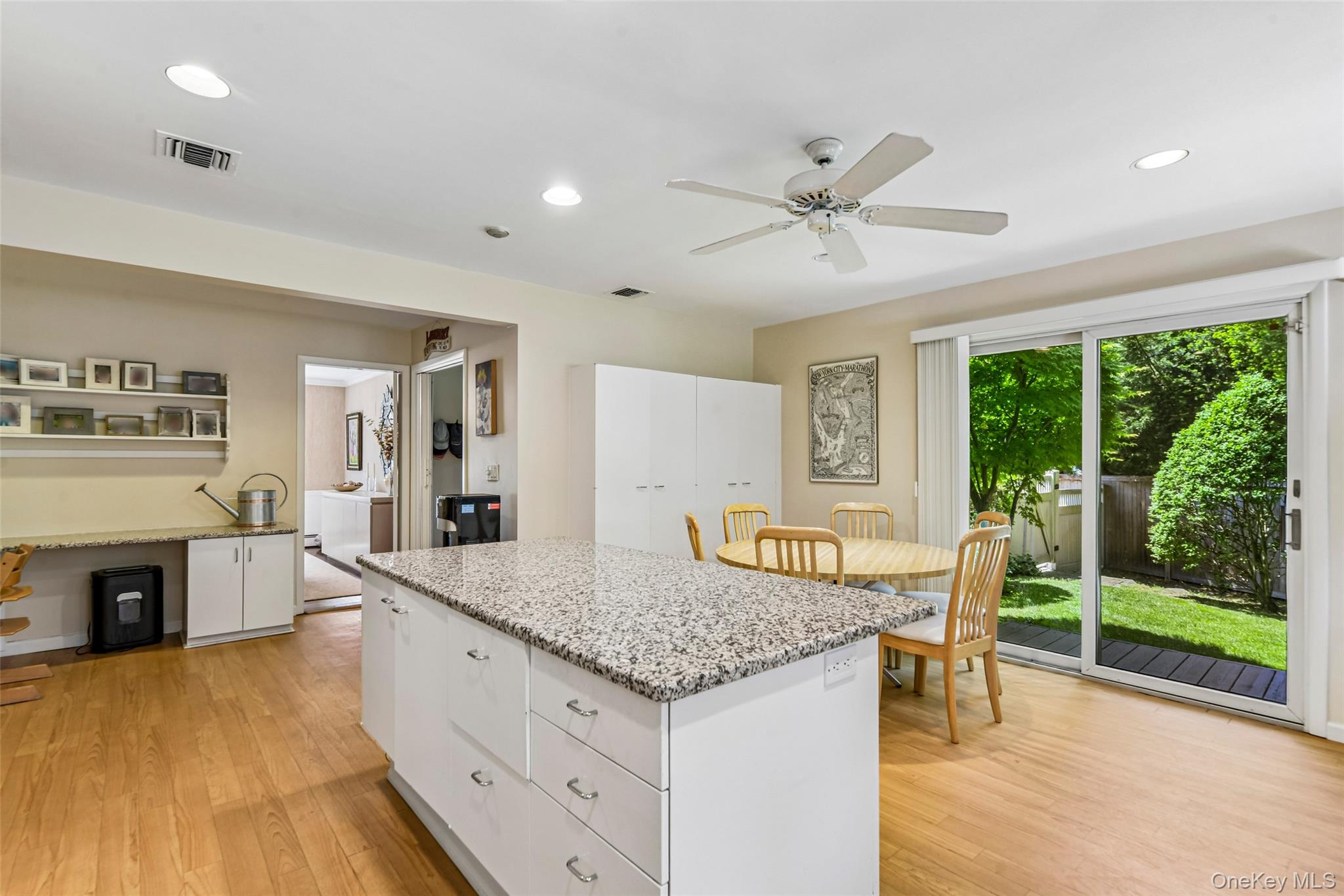 100 Hewlett Neck Road Woodmere, NY 11598 - Photo 15 of 45 a kitchen with granite countertop center island wooden floor and appliances
