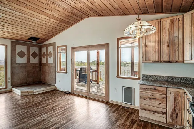 a view of a hallway with wooden floor and entryway