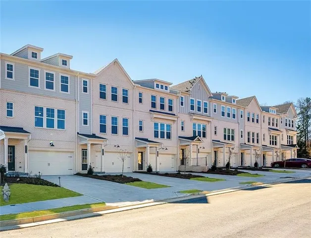 a view of white house with a yard in front of it