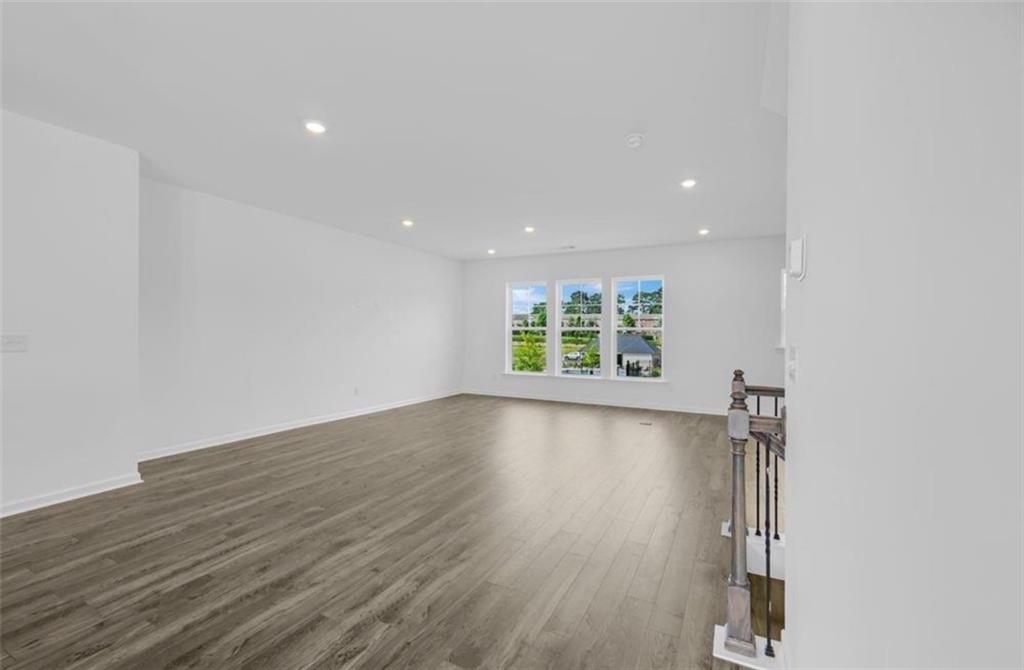 206 Maycrest Path Tucker, GA 30084 - Photo 5 of 18 an empty room with wooden floor and windows