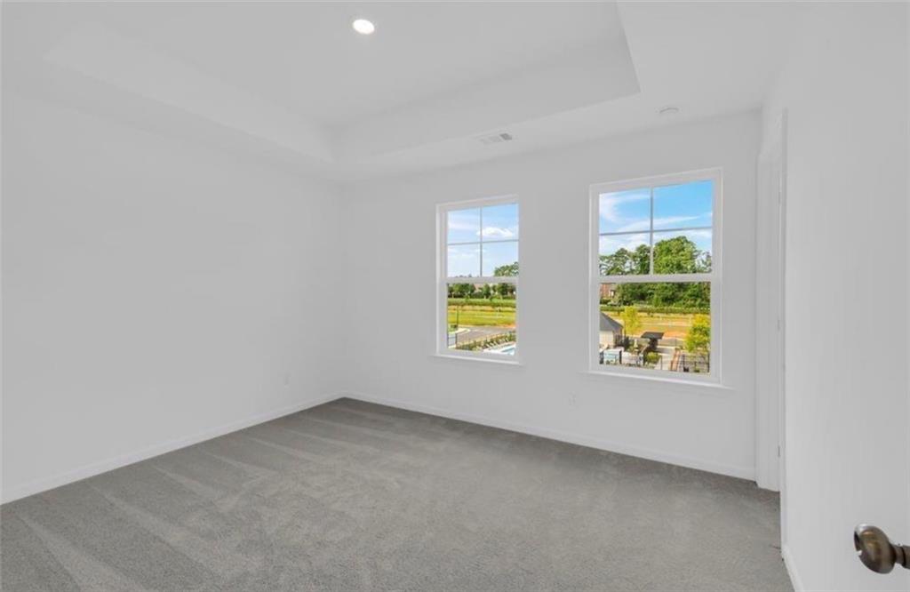 206 Maycrest Path Tucker, GA 30084 - Photo 8 of 18 an empty room with windows and mirror