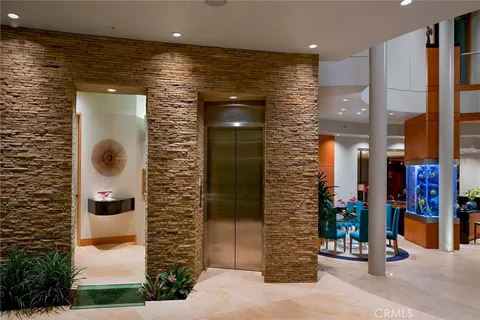 a living room with furniture pool table and chairs