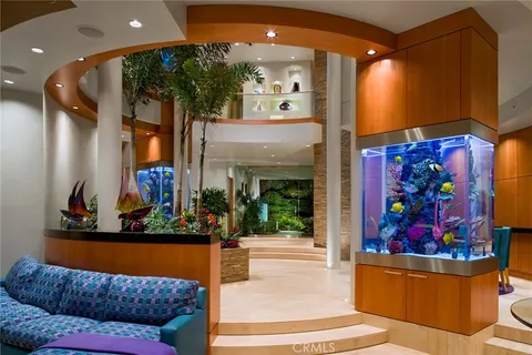 a living room with furniture and floor to ceiling window