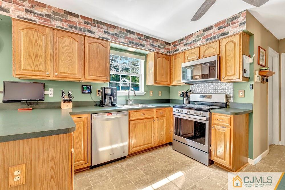 5 Netty Street Howell, NJ 07731 - Photo 12 of 36 a kitchen with stainless steel appliances granite countertop a stove a sink and a microwave