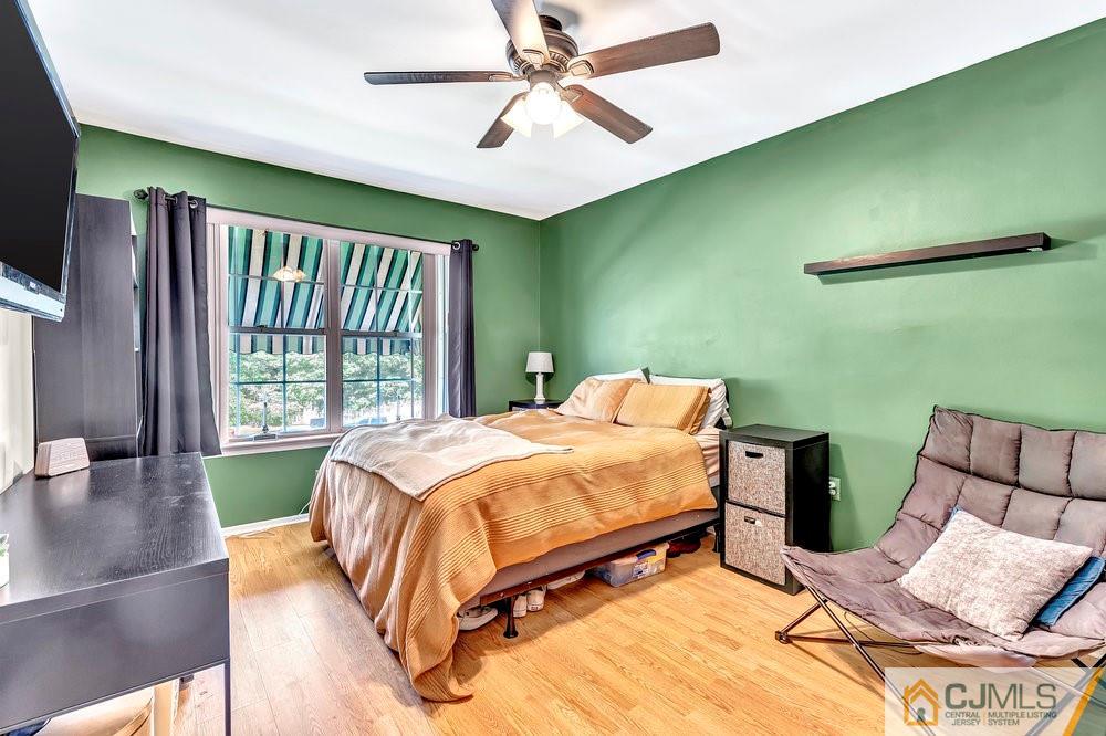 5 Netty Street Howell, NJ 07731 - Photo 25 of 36 a bedroom with a bed window and a flat screen tv