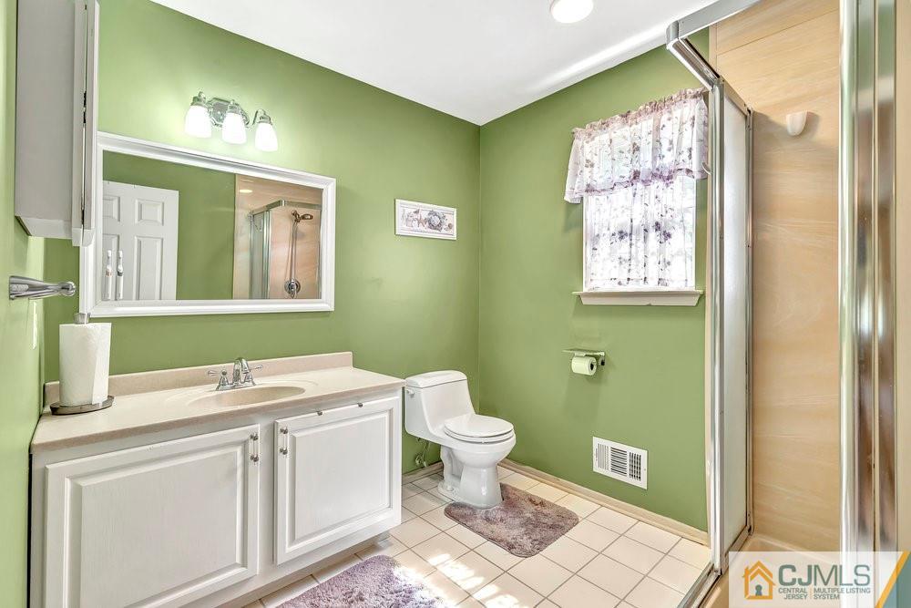 5 Netty Street Howell, NJ 07731 - Photo 27 of 36 a bathroom with a sink a toilet and a mirror