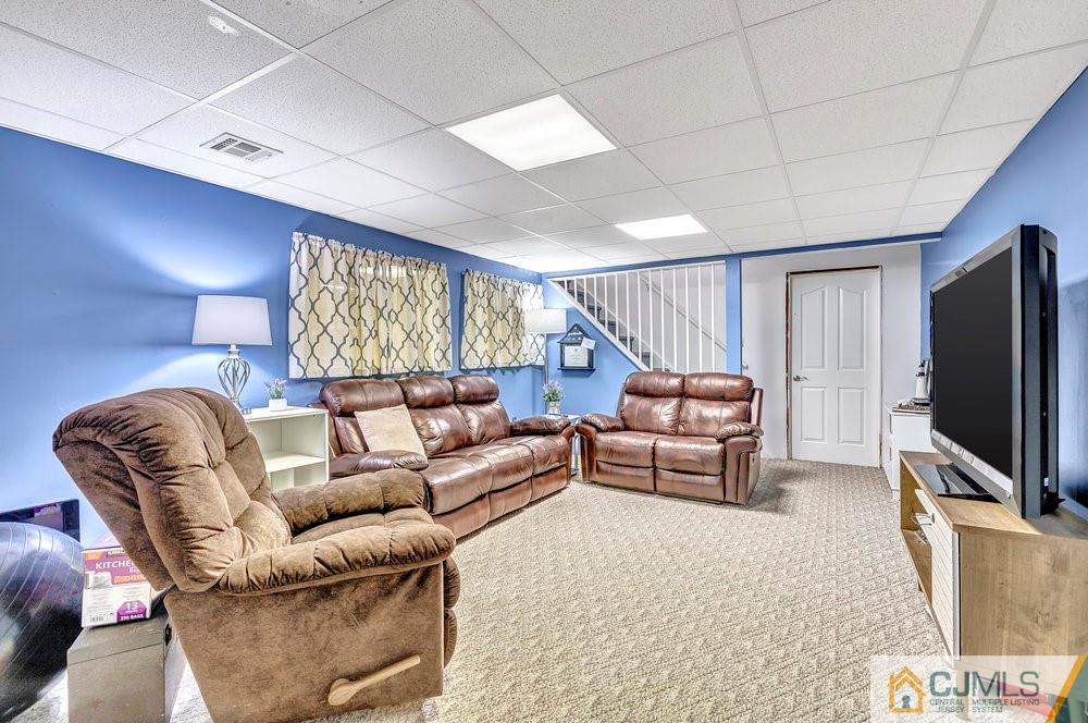 5 Netty Street Howell, NJ 07731 - Photo 28 of 36 a living room with furniture and a flat screen tv
