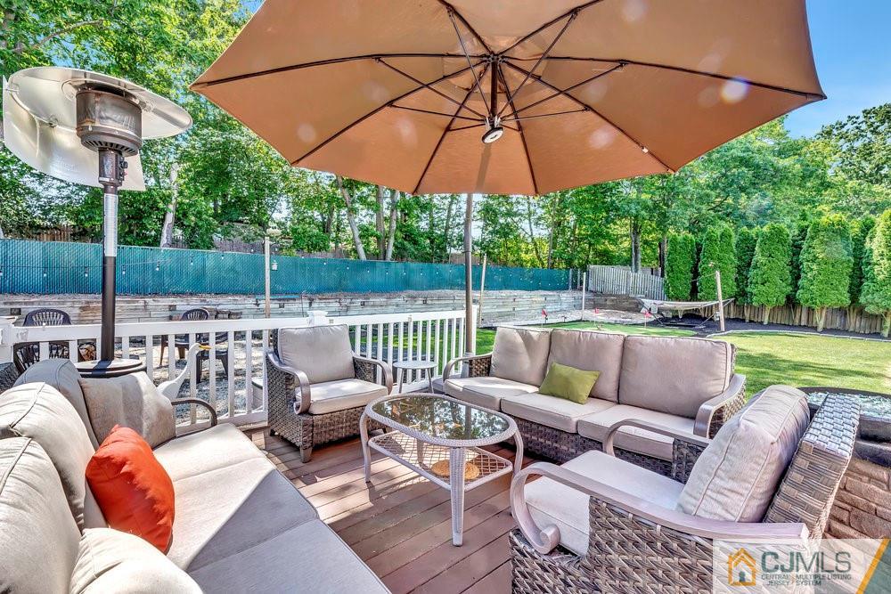 5 Netty Street Howell, NJ 07731 - Photo 31 of 36 a patio with patio a table and chairs under an umbrella